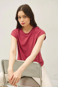 Woman wearing a dark red bamboo cap sleeve basic round neck top