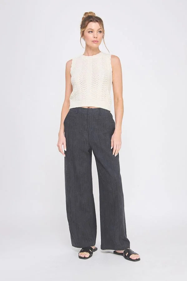 Woman wearing textured wide leg pants with back elastic waist and sleeveless top