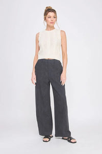 Woman wearing textured wide leg pants with back elastic waist and sleeveless top