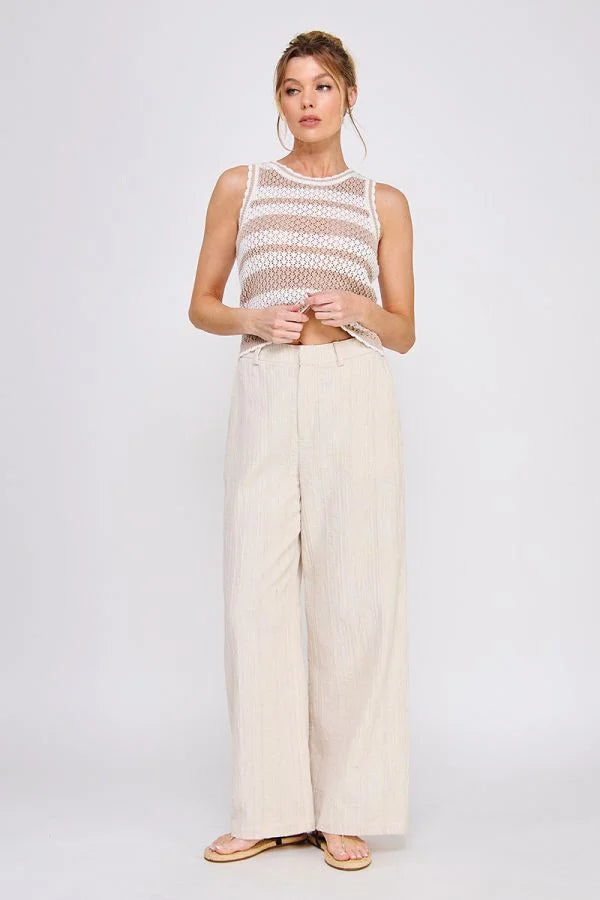 Woman in striped knit tank top wearing textured wide leg pants with back elastic waist