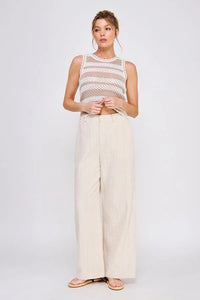 Woman in striped knit tank top wearing textured wide leg pants with back elastic waist