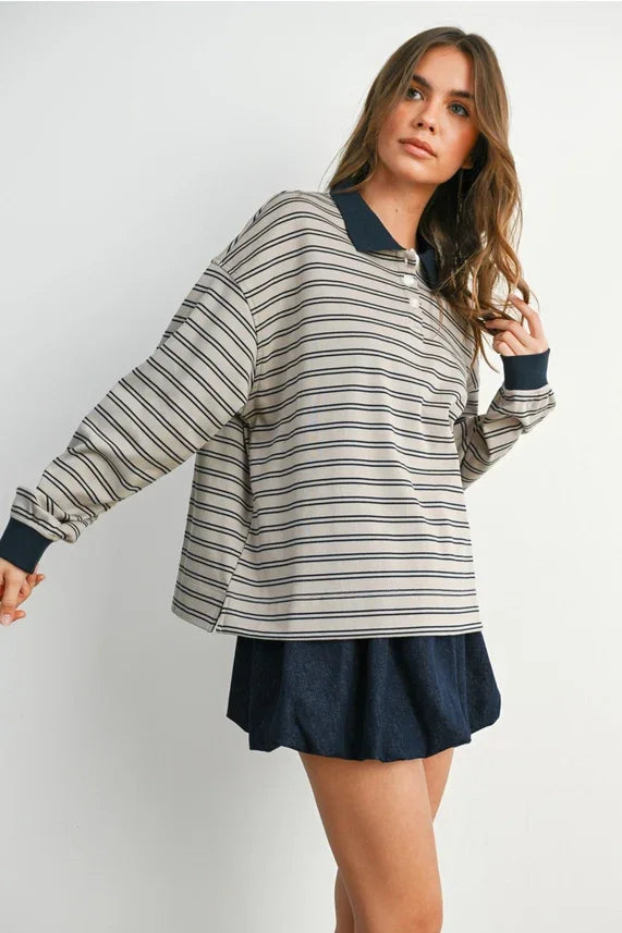 Woman wearing a striped collared long sleeve top and navy skirt for the QUARTER-BUTTON product