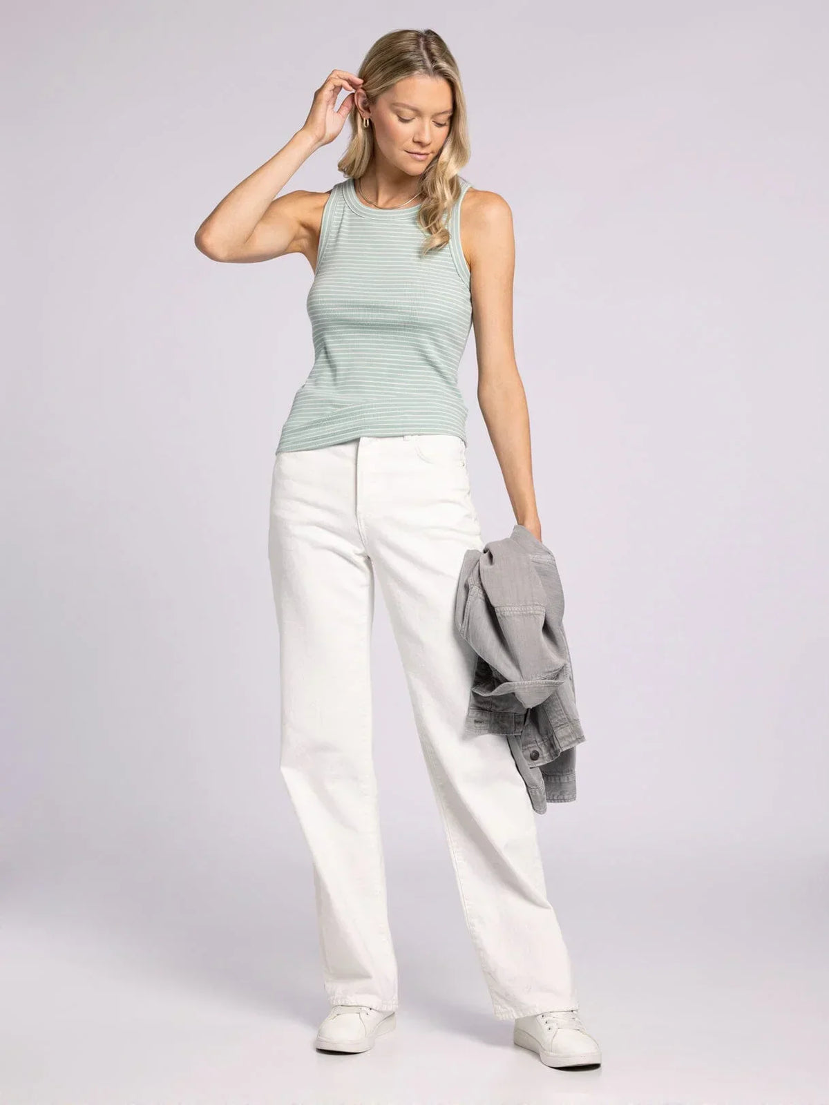 Woman in striped tank top and white pants showcasing the Edlin Basic Tank