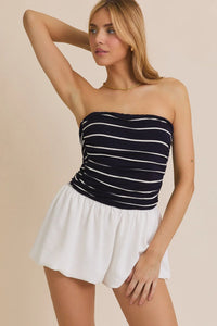 Woman wearing a tube stripe woven shorts mix romper with striped tube top and white shorts