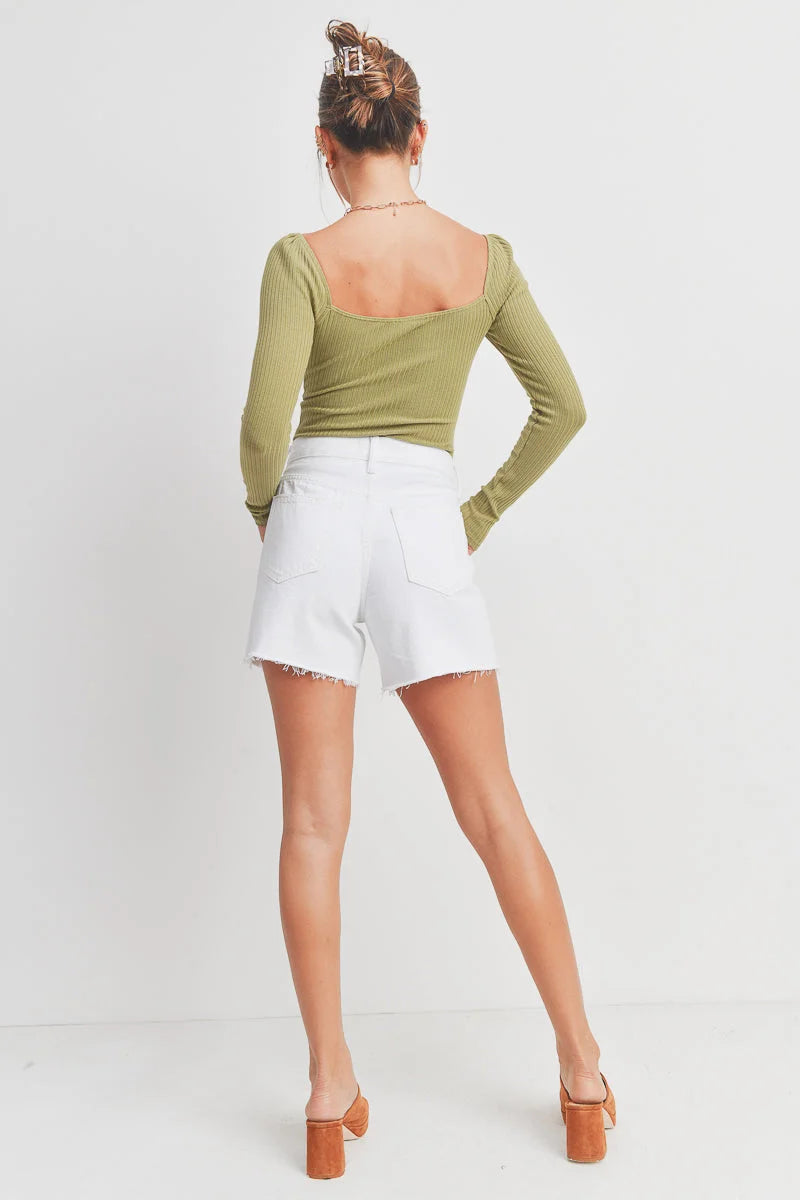 Woman wearing white denim shorts from SUMMER BOYFRIEND SHORT, perfect for women’s boho chic clothing