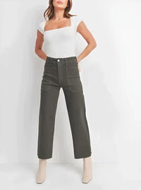 Woman in a white top and green pants showcasing Nautical Wide Leg Denim style