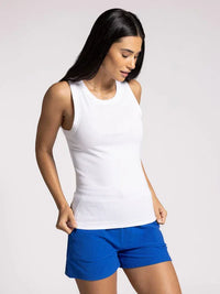 Woman in EDLIN BASIC TANK and bright blue shorts showcasing a stylish summer look