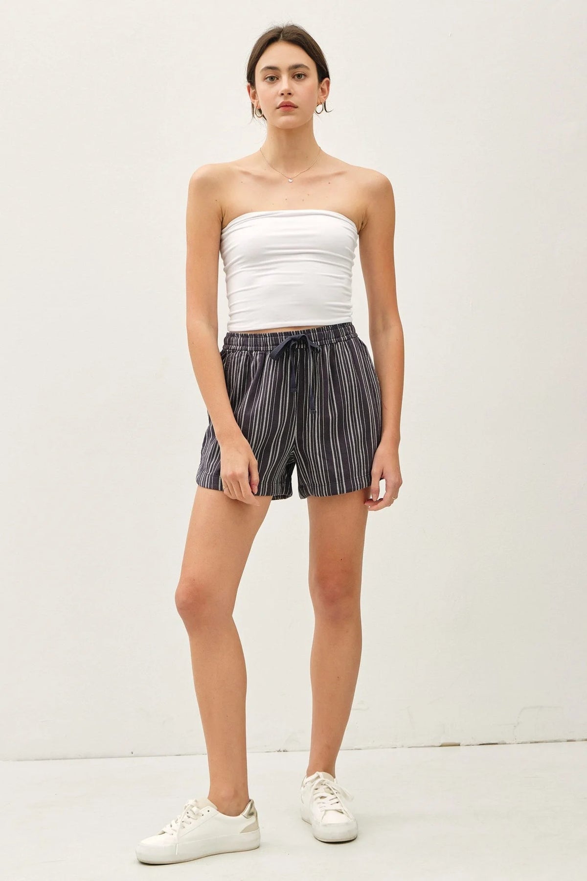 Woman in white tube top and cotton blend striped shorts showcasing Breezy Cotton Blend Striped Shorts