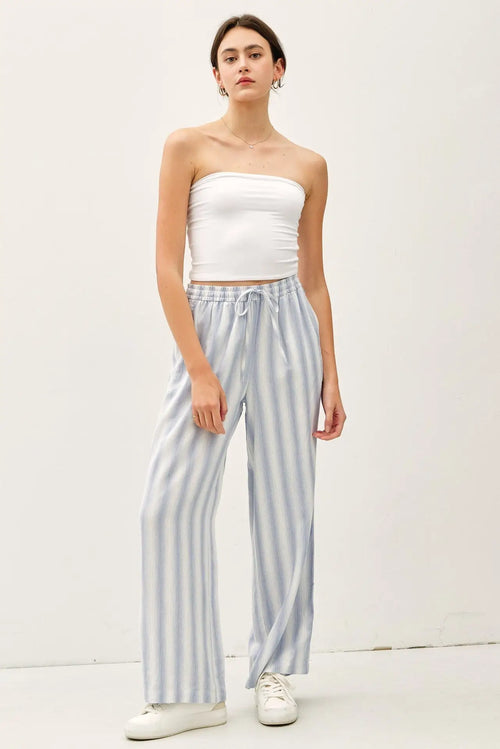 Woman wearing ombre striped wide-leg trousers with a drawstring waist