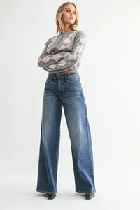 Woman wearing high rise wide leg denim jeans and bohemian argyle sweater