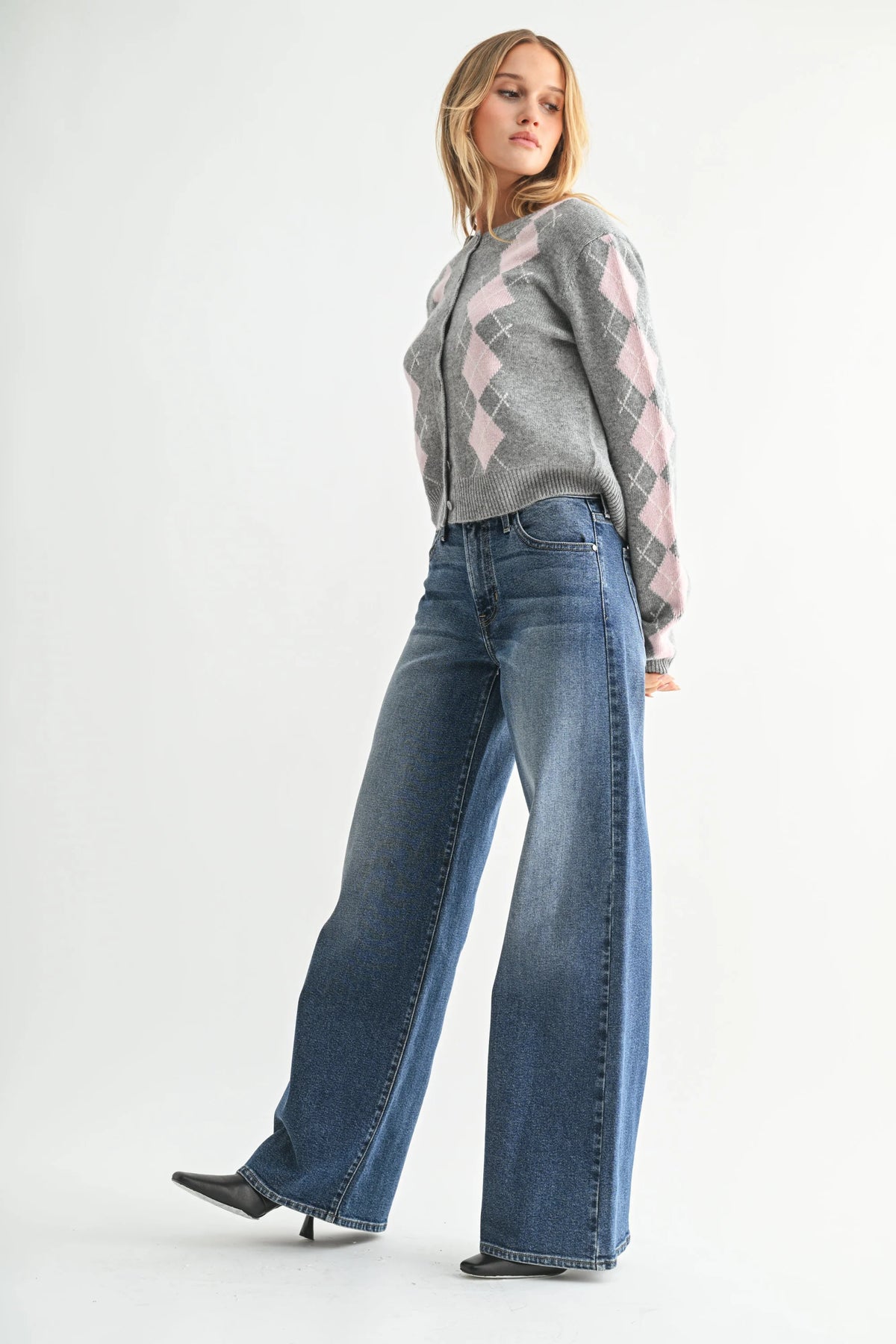 Woman wearing high-rise ultra wide-leg denim jeans with a bohemian style