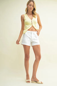 Woman in a yellow top and white shorts wearing the Original Utility Short for casual style