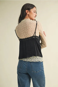 Woman’s black lace-trim V neck cami top layered over beige long-sleeve lace blouse for women’s boho chic clothing