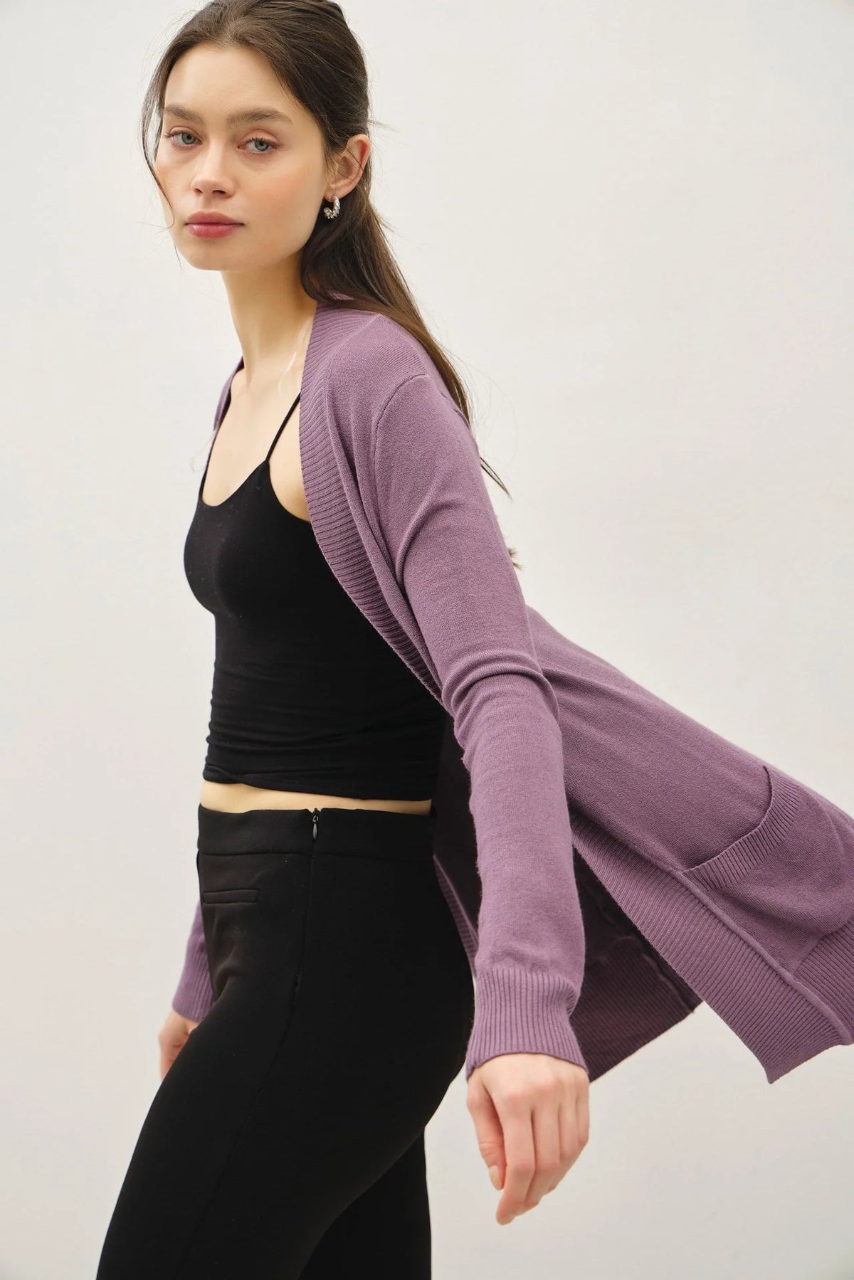 Woman wearing black tank top and purple cotton blend knit open front cardigan