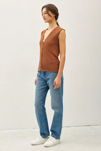 Woman wearing brown knit vest and jeans from shop Daisy in women’s boho chic clothing