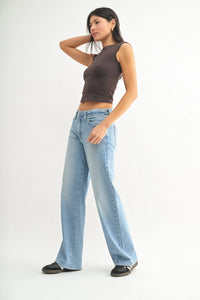Woman wearing low slung vintage straight denim jeans in a casual outfit setting