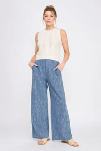 Woman’s casual outfit featuring textured wide leg pants with back elastic waist
