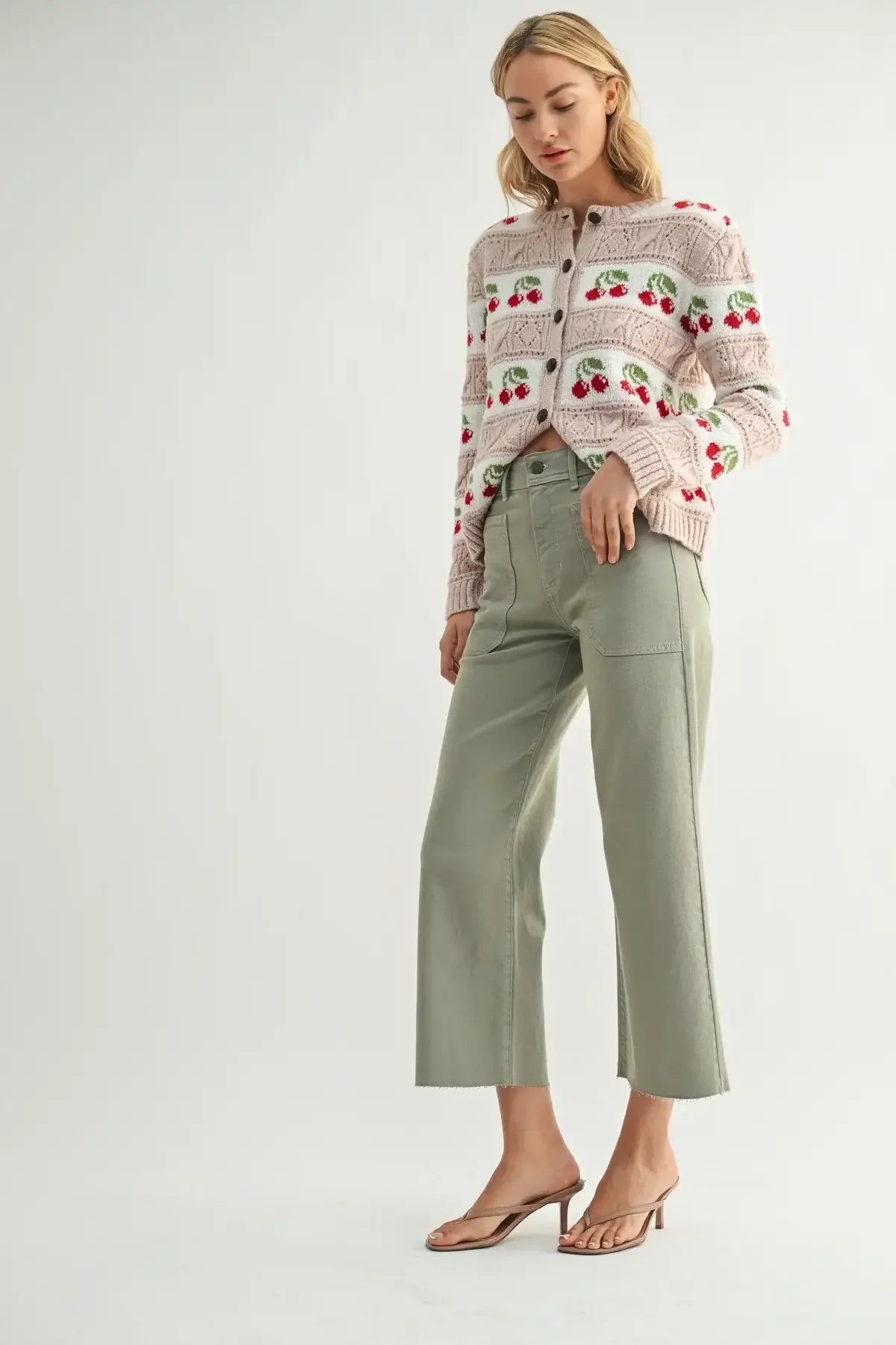 Woman wearing cherry-patterned cardigan and green pants paired with NAUTICAL HIGH RISE WIDE LEG DENIM