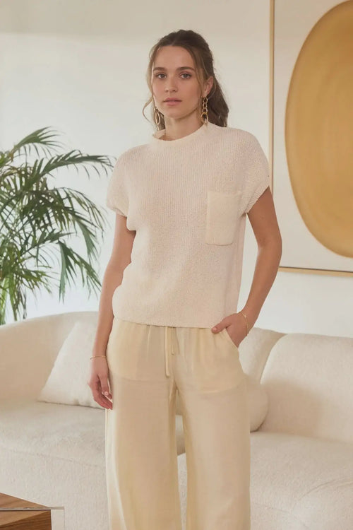 Womenās cream-colored knit top and pants set from Shop Daisy, ideal for womenās boho chic clothing