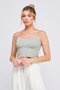 Woman wearing a smooth rib bralette tank with laser cut back detail