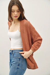 Woman wearing an open-front crochet knit cardigan from the Crochet Knit Cardigan collection