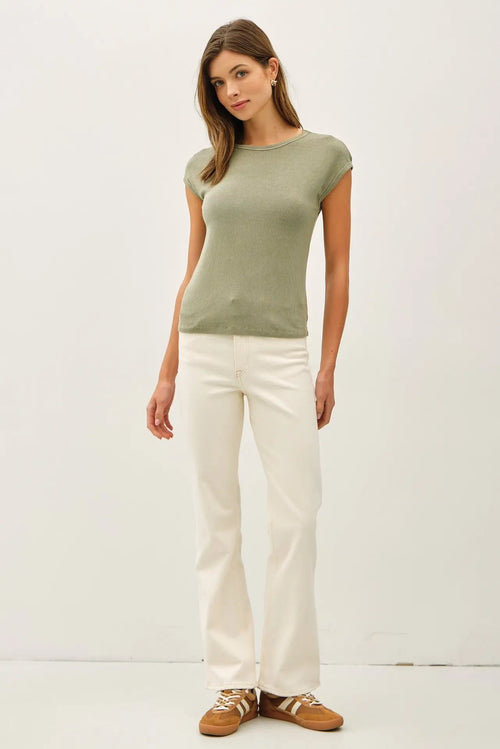 Woman wearing a ribbed cap sleeve T-shirt with white jeans, stylish and comfortable fashion