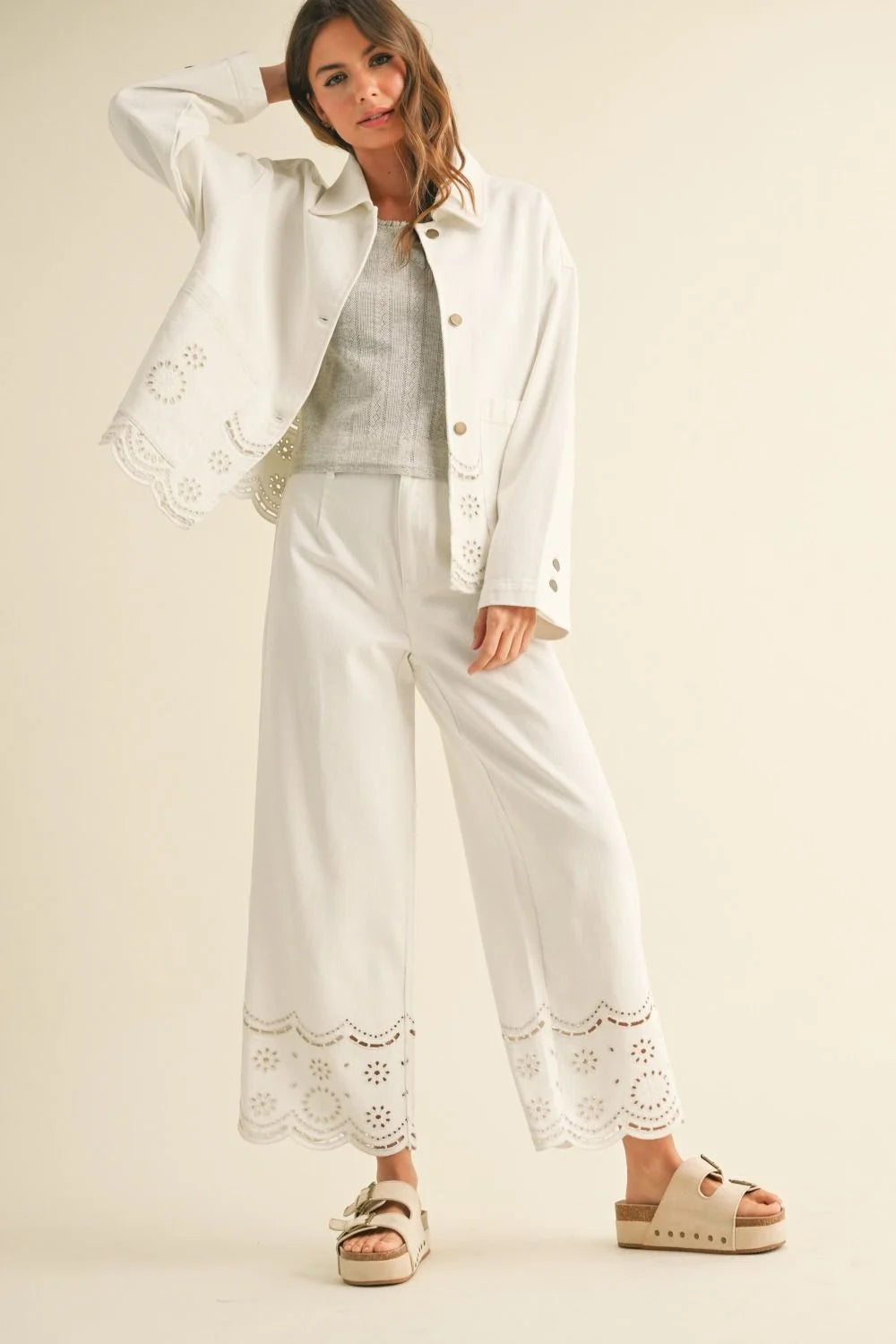 Elegant woman’s white eyelet-trimmed outfit from Shop Daisy, perfect for women’s boho chic clothing