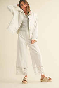 Elegant woman’s white eyelet-trimmed outfit from Shop Daisy, perfect for women’s boho chic clothing