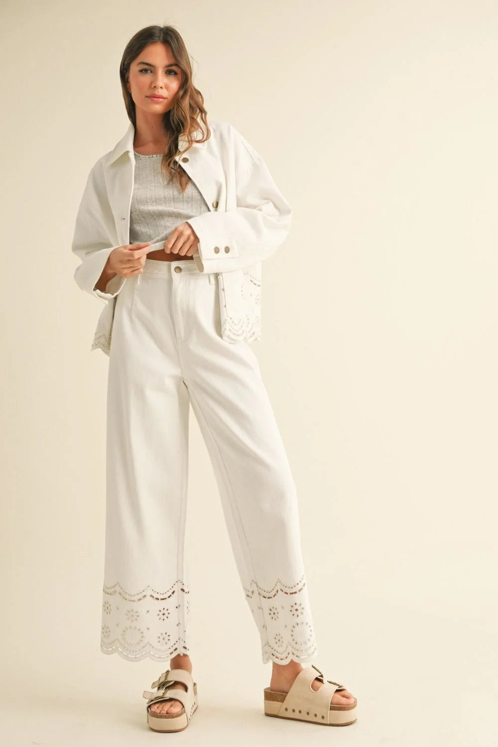 Woman in a white outfit featuring EMBROIDERY BOTTOM PANTS from Shop Daisy’s women’s boho chic clothing