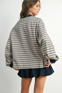 Beige and black striped collared long sleeve shirt paired with a dark blue mini skirt