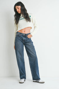 Women’s cable-knit cropped sweater paired with straight leg denim for women’s boho chic clothing at Shop Daisy