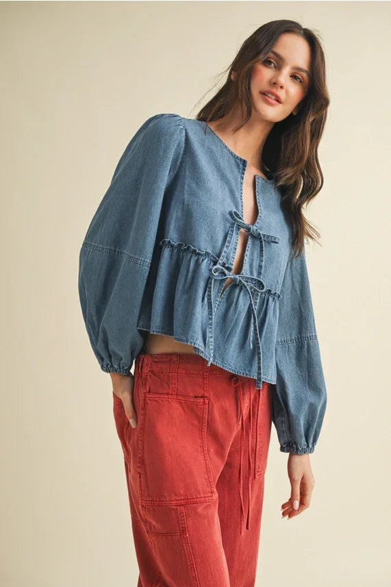 Women’s denim peasant blouse with ruffle hem and tie closure paired with red cargo pants
