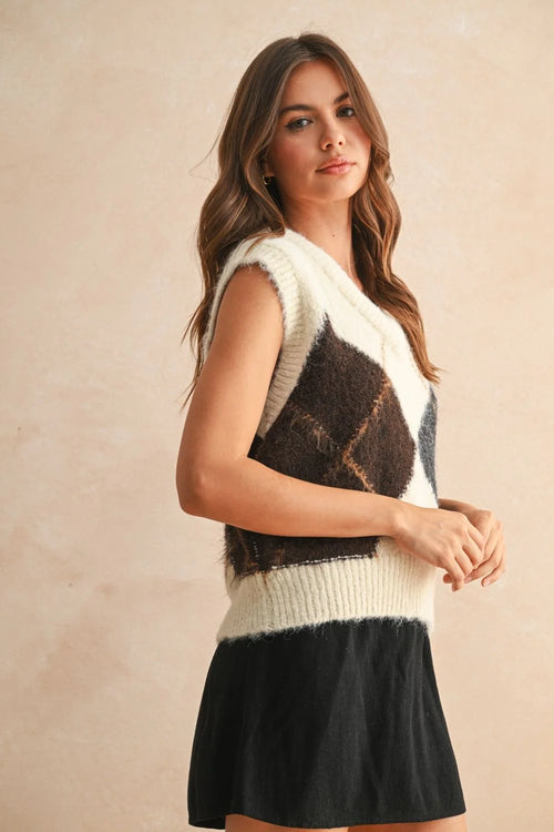 Womenās fuzzy argyle pattern sweater vest paired with a black skirt for a stylish look