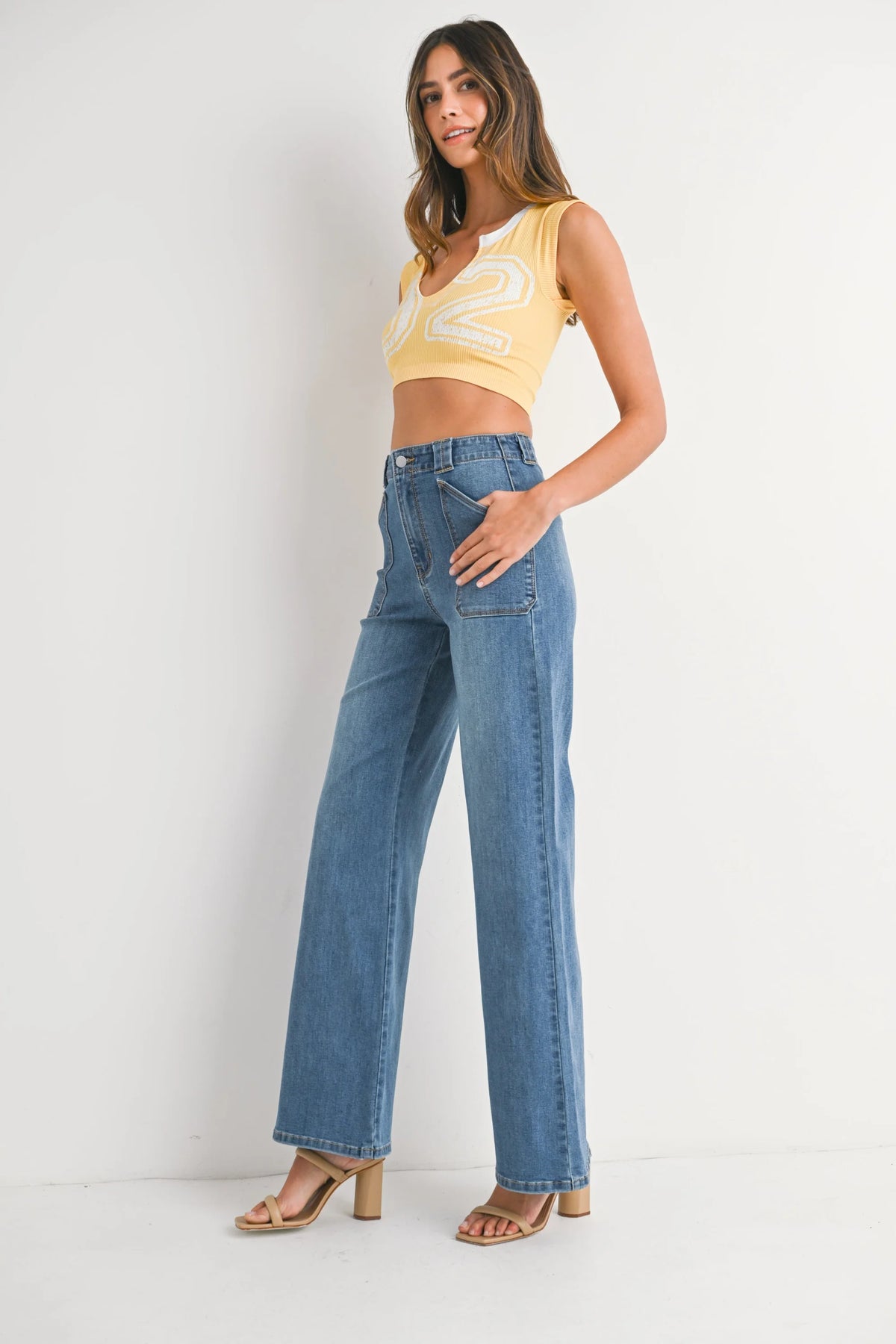Women’s light wash blue high-waisted wide leg flare denim jeans with patch pockets
