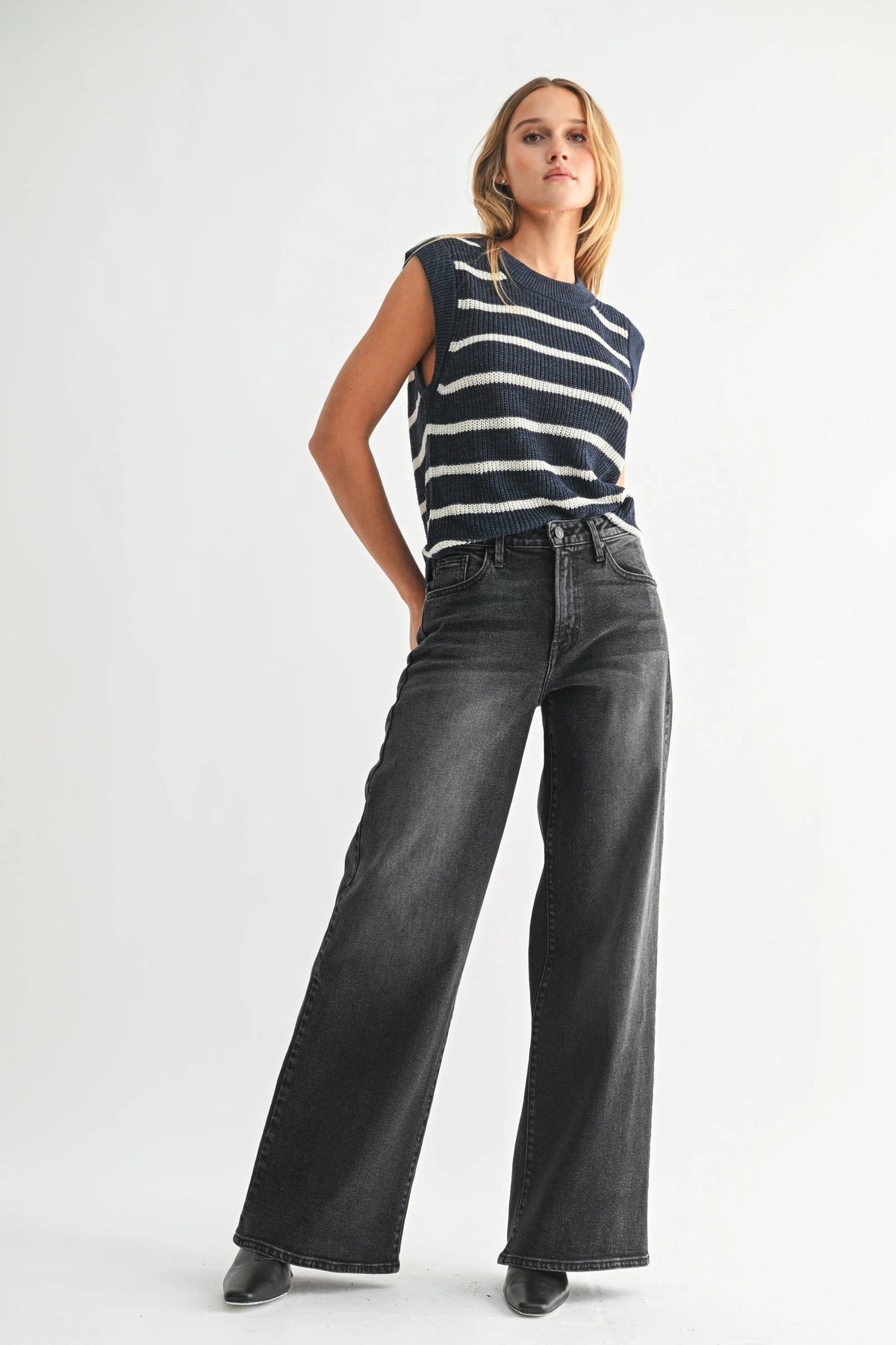 Women’s navy and white striped sleeveless sweater with high-rise wide-leg bohemian denim jeans
