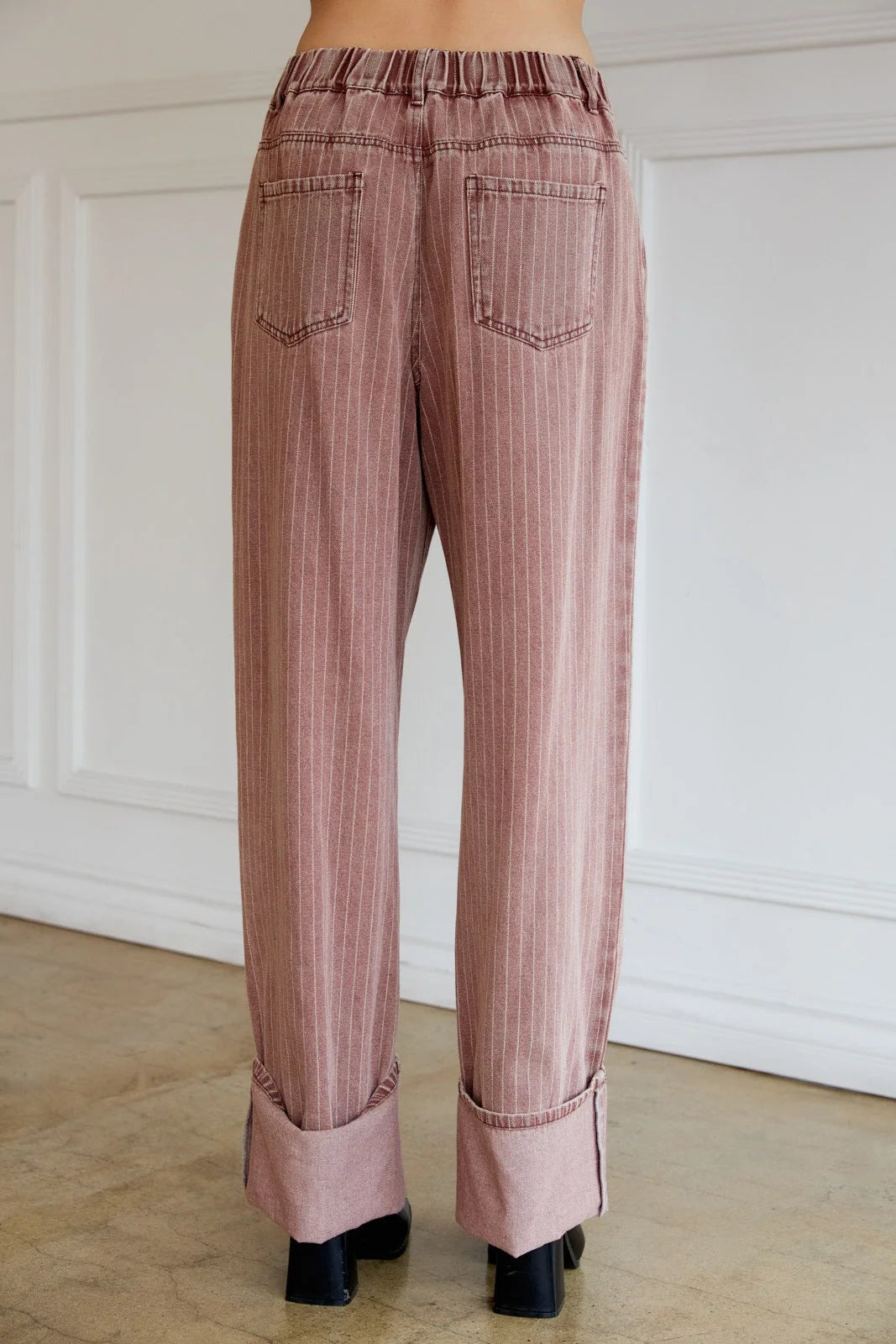 Women’s pink wide leg strip denim pants with elastic waist and cuffed hems