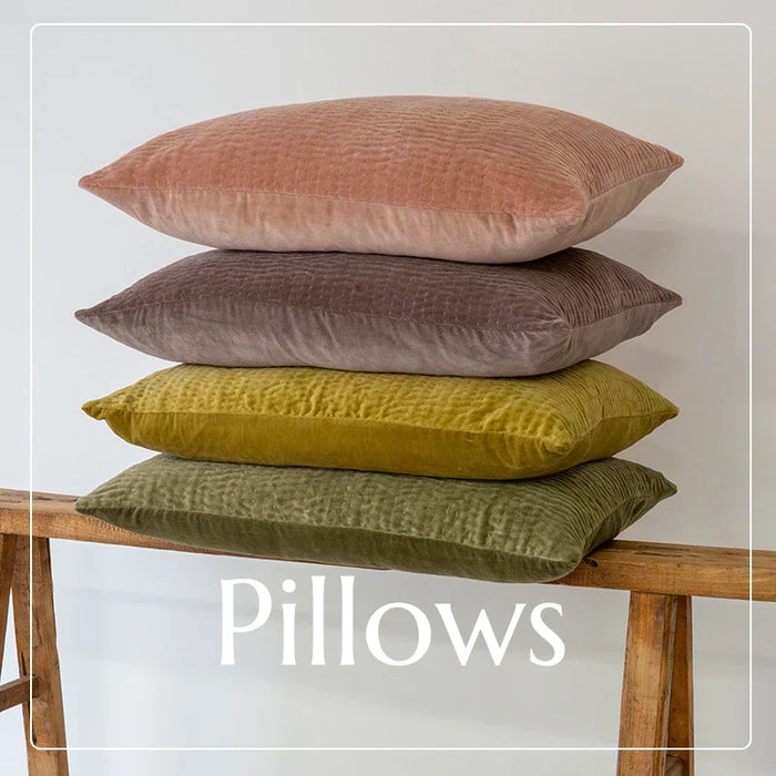 Stack of four muted earth tone throw pillows from Daisy Lane for stylish home decor.