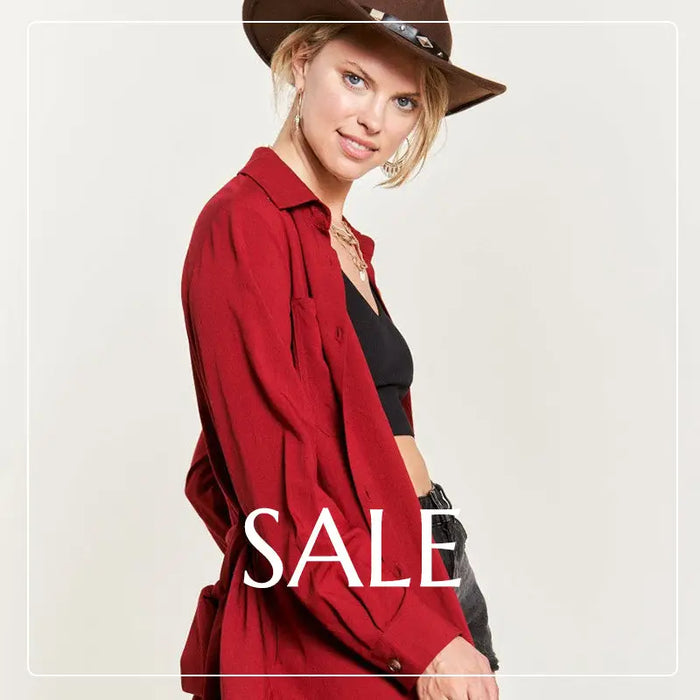 Red blazer over black top with brown hat, a stylish boho sale item.