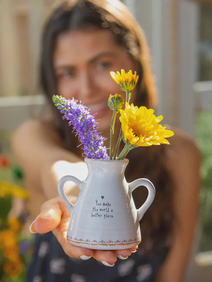 Small white vase with flowers, an ideal Valentine’s Day gift for her.