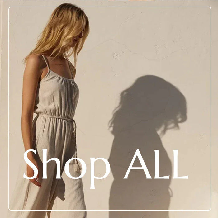 Woman in a light-colored sleeveless jumpsuit from the latest clothing collection to shop.