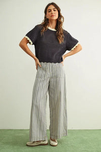 Navy blue crocheted top with cream ruffles on Stripe print pocket front pants