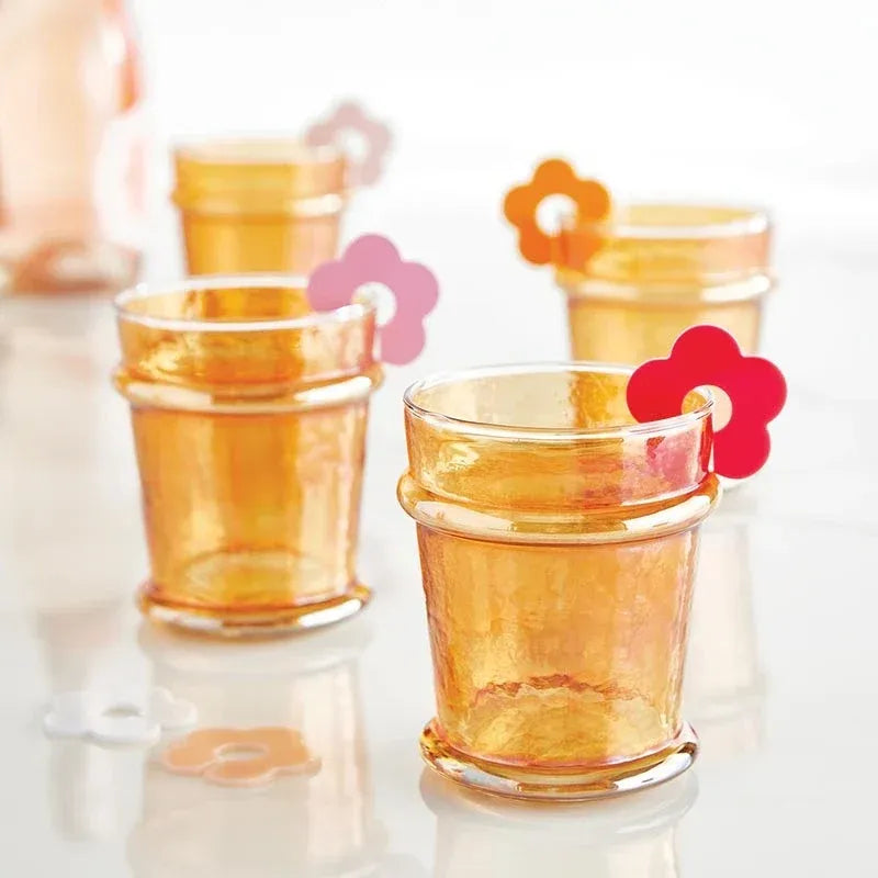 Amber-colored everyday luster glass tumblers with textured hammered finish and rounded rims in tangerine hue