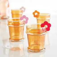 Amber-colored everyday luster glass tumblers with textured hammered finish and rounded rims in tangerine hue
