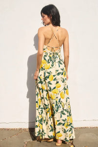 A flowing backless maxi dress featuring a vintage lemonade knot front in vibrant yellow lemon and green leaf print