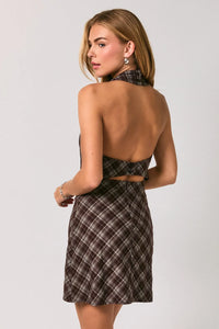 Back view of a dark brown and cream plaid mini dress with a halter neckline and open back cutout details