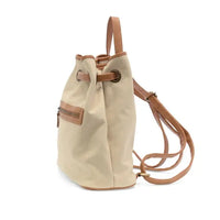 Beige memphis canvas backpack with tan leather accents and drawstring straps in durable canvas material