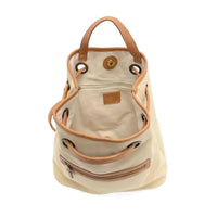 Beige canvas memphis canvas backpack with tan leather handles and trim in a stylish bucket bag design
