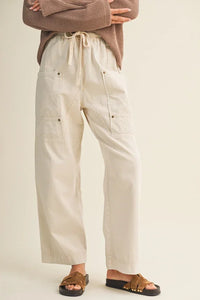 Beige pocket wide pants with drawstring, flap pockets and stitching