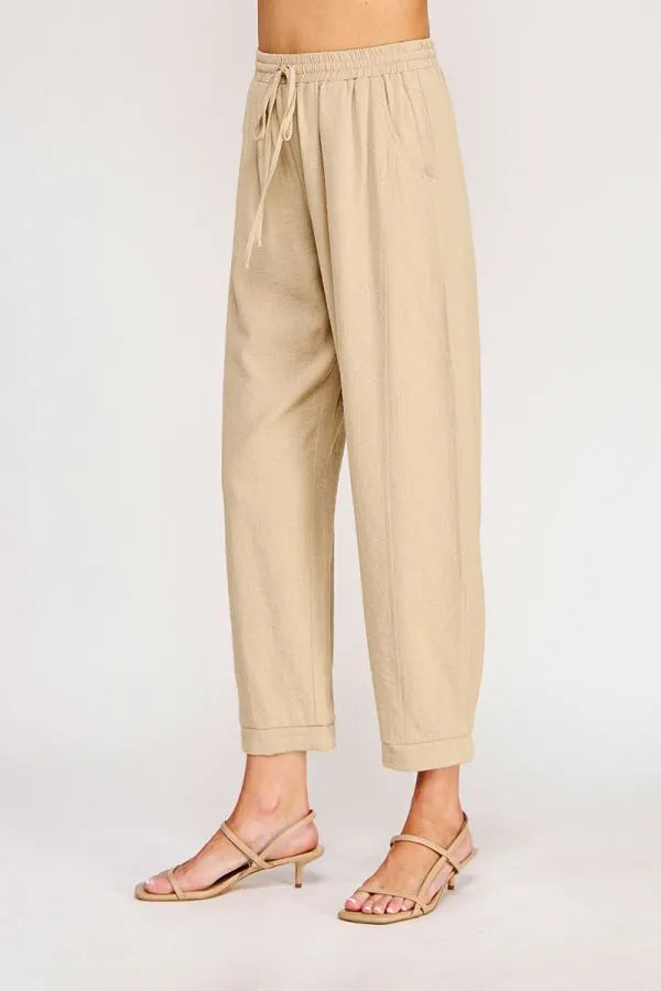 Beige cotton rayon linen blend relaxed tapered pants with drawstring waist and rolled cuffs for casual wear