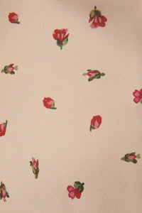 Beige fabric with small red roses and green stems on a ruched bust floral midi dress with spaghetti straps